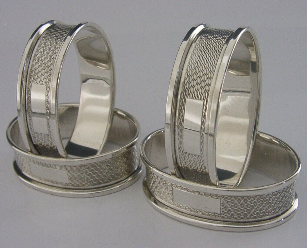 SET OF FOUR ENGLISH SOLID STERLING SILVER ENGINE TURNED NAPKIN RINGS 1960