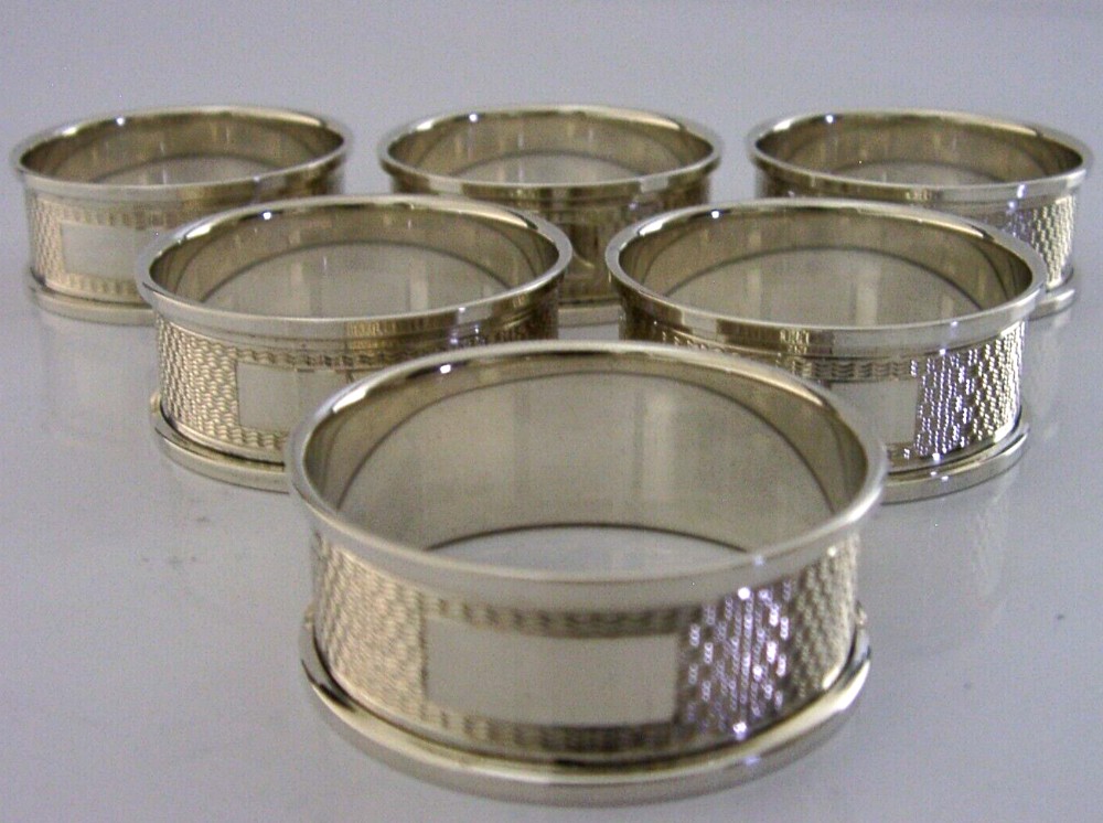 SIX ENGLISH STERLING SILVER ENGINE TURNED NAPKIN RINGS 1953