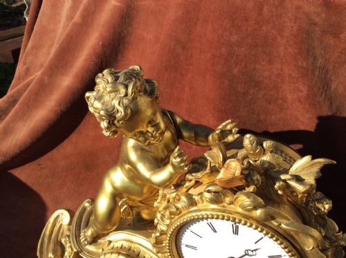 Gilt Clock with Putti & Butterfly on Flower