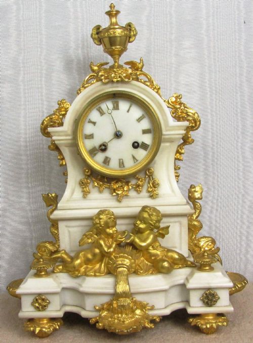 Gilt Ormolu and White Marble Le Roy & Fils Paris 8 Day Striking Clock with Cherubs and Dolphins