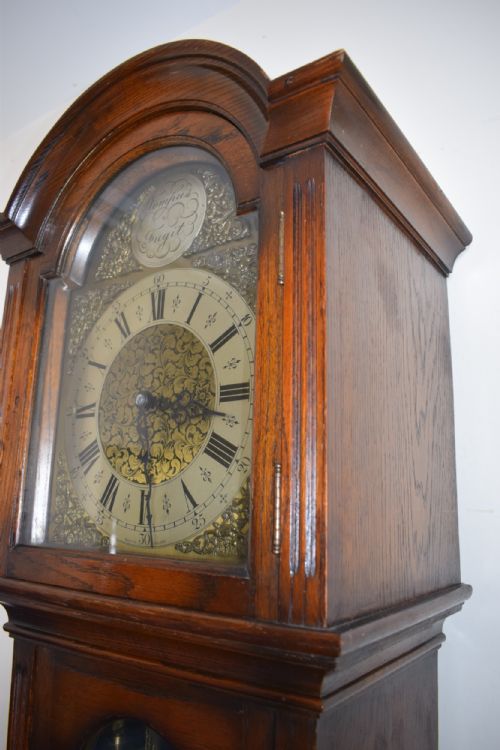 fig 1. English Triple Weight Westminster Musical Chiming Grandmother or Grandfather English Oak with Glazed Trunk Door Longcase Clock. Circa 1920s