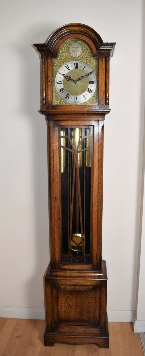 Whittington Musical Chiming English Warm Honey Coloured Oak Grandmother or Grandfather Longcase Clock with Glazed Trunk Door Raised on Bracket Feet - Circa 1920