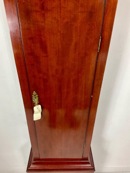 fig 1. An 18th-century Georgian mahogany longcase clock featuring an arched brass dial with an engraved maker silvered boss and brass spandrels.