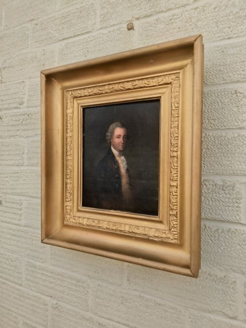 fig 1. A nineteenth-century oil portrait of a gentleman dressed in period attire set within a deep gilded moulded wooden frame.