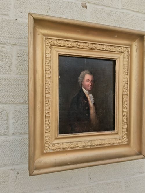 fig 2. A nineteenth-century oil portrait of a gentleman dressed in period attire set within a deep gilded moulded wooden frame.