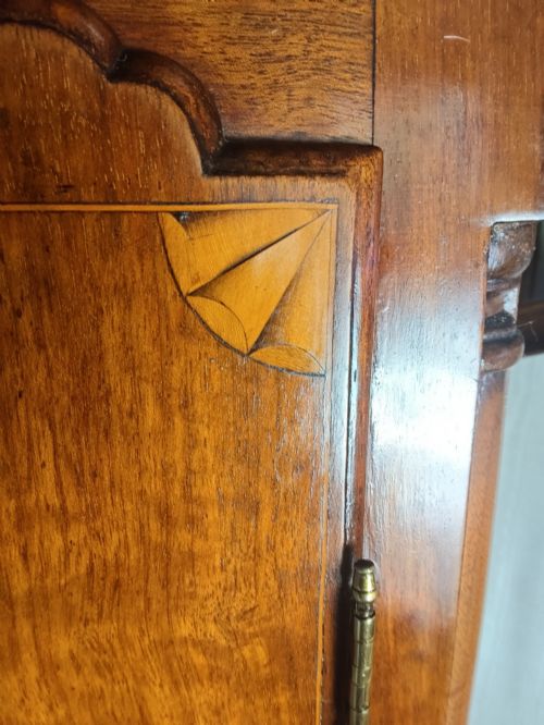 fig 1. A 19th-century mahogany grandfather clock featuring a swan-neck pediment, brass arch dial, and decorative inlaid paterae on the trunk door.