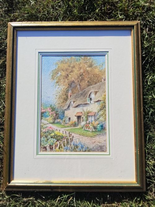 fig 1. A framed vertical watercolour painting depicting a traditional thatched cottage with a garden filled with colourful flowers under a blue sky.