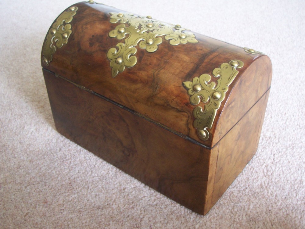 A Victorian burr walnut stationery box featuring a domed lid decorated with pierced brass mounts and corner straps. View VII