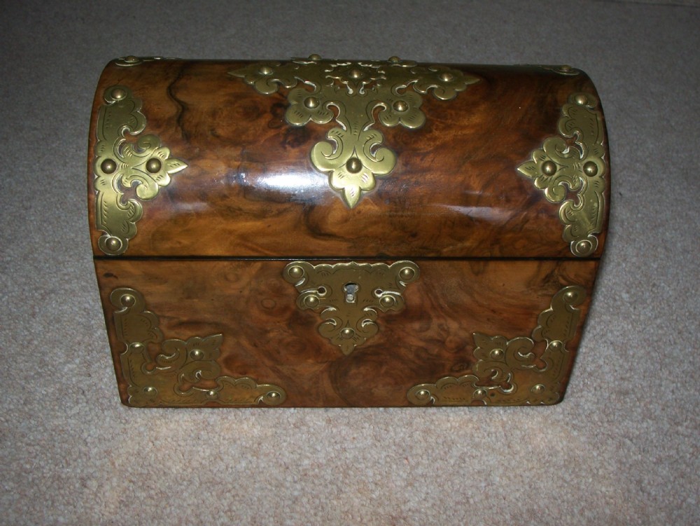 A Victorian burr walnut stationery box featuring a domed lid decorated with pierced brass mounts and corner straps. View VIII