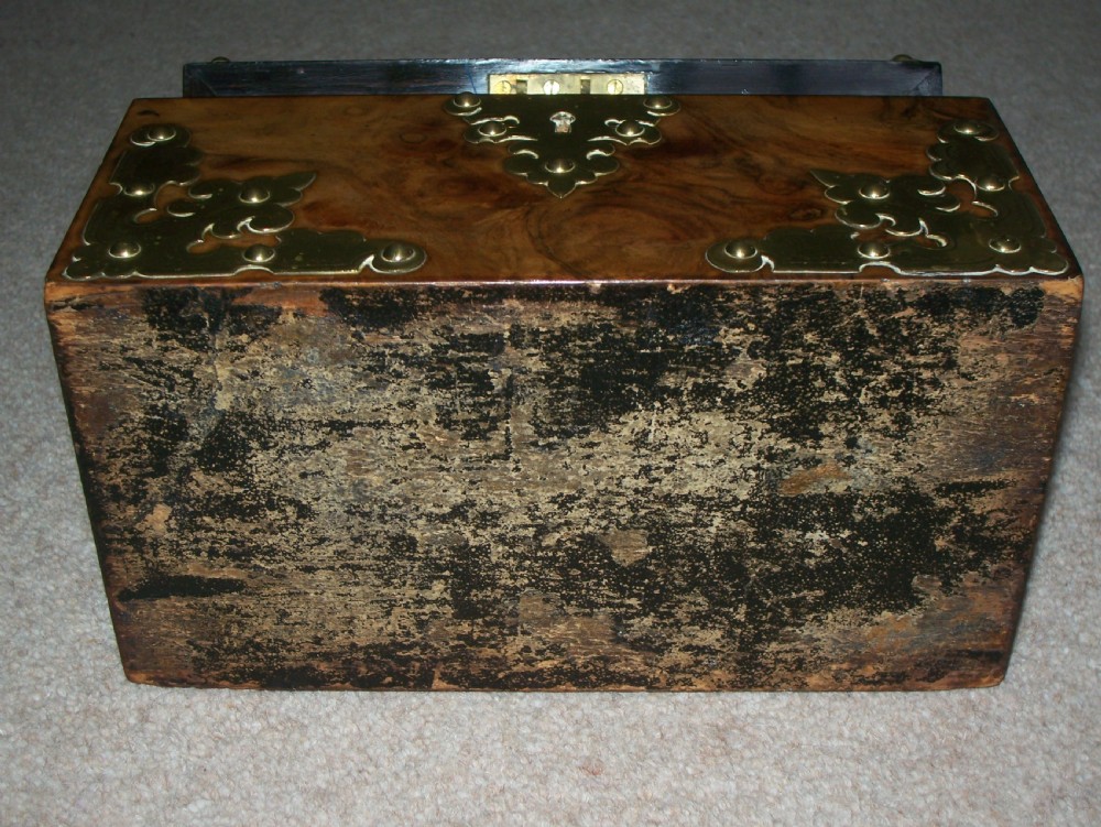 A Victorian burr walnut stationery box featuring a domed lid decorated with pierced brass mounts and corner straps. View IX