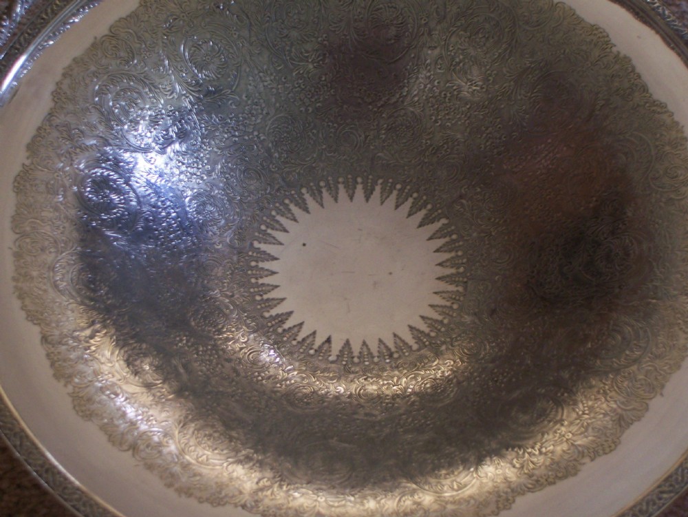 A Victorian silver-plated oval cake basket featuring a twisted overhead swing handle and a raised pedestal base. View III