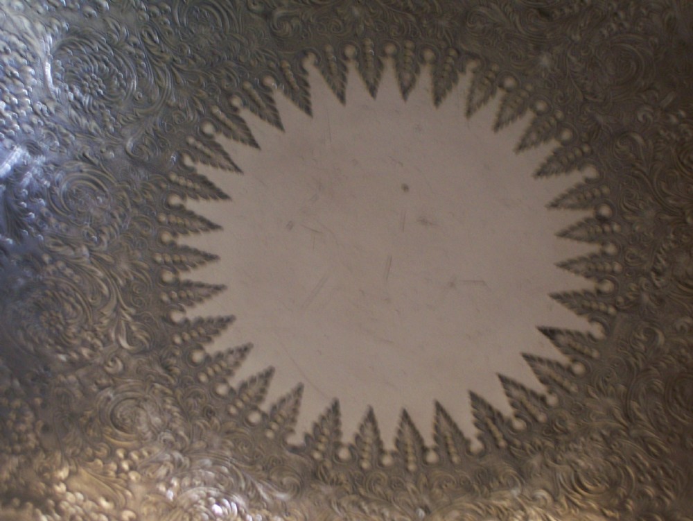 A Victorian silver-plated oval cake basket featuring a twisted overhead swing handle and a raised pedestal base. View VI