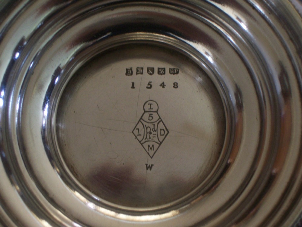 A Victorian silver-plated oval cake basket featuring a twisted overhead swing handle and a raised pedestal base. View VII