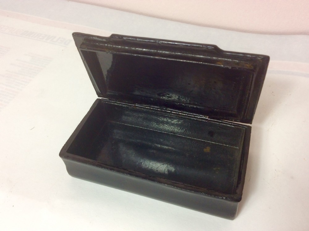 A rectangular black lacquered papier-mache table snuff box featuring hand-painted floral scrollwork and star-shaped mother-of-pearl inlays on the lid. View III