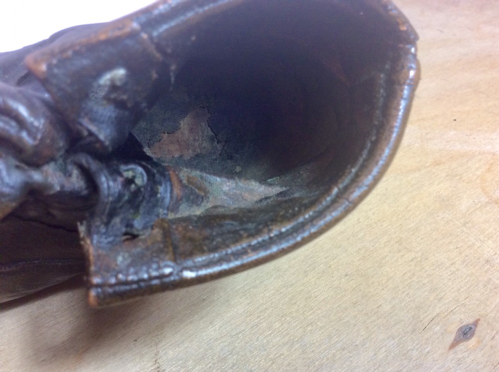An early twentieth-century infant leather shoe preserved with an electroplated copper coating, featuring tied laces and creased detail. View V