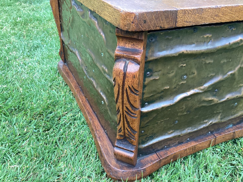 An Arts and Crafts oak log box featuring hammered copper panels with decorative repousse detailing and riveted edges. View VI