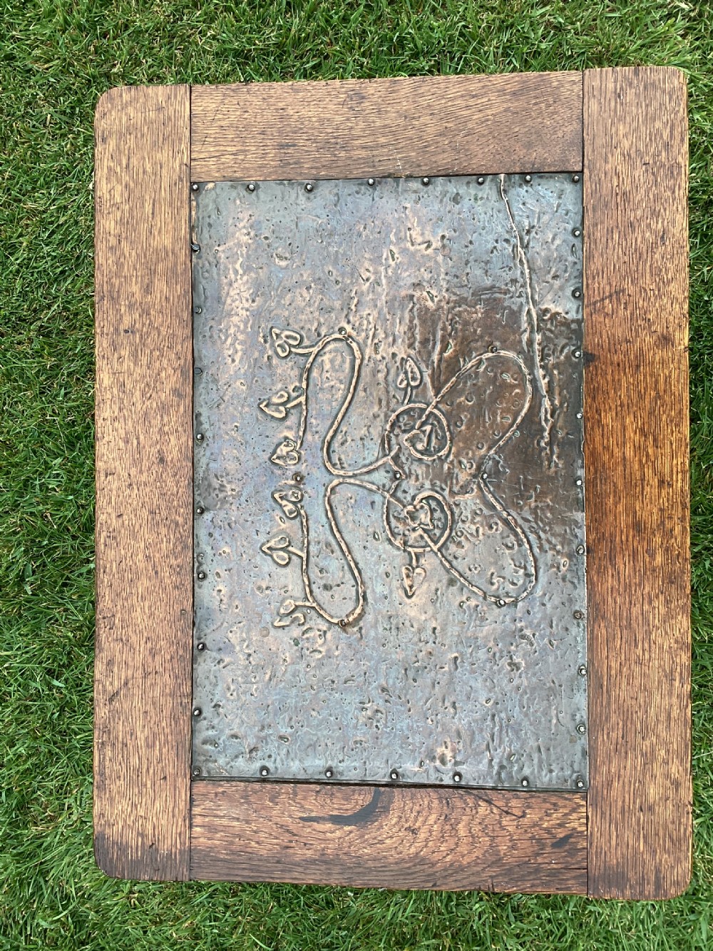 An Arts and Crafts oak log box featuring hammered copper panels with decorative repousse detailing and riveted edges. View IX
