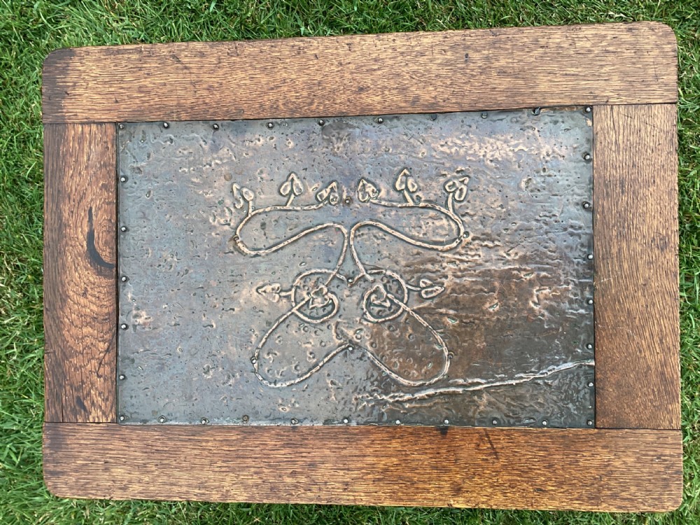 An Arts and Crafts oak log box featuring hammered copper panels with decorative repousse detailing and riveted edges. View XI