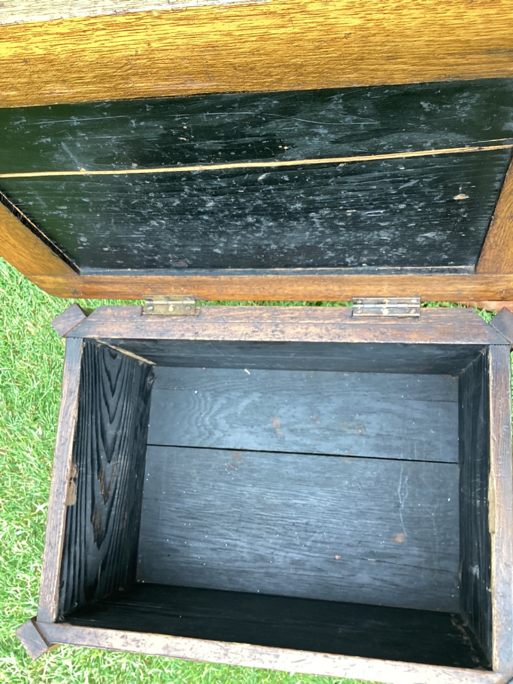 An Arts and Crafts oak log box featuring hammered copper panels with decorative repousse detailing and riveted edges. View XII