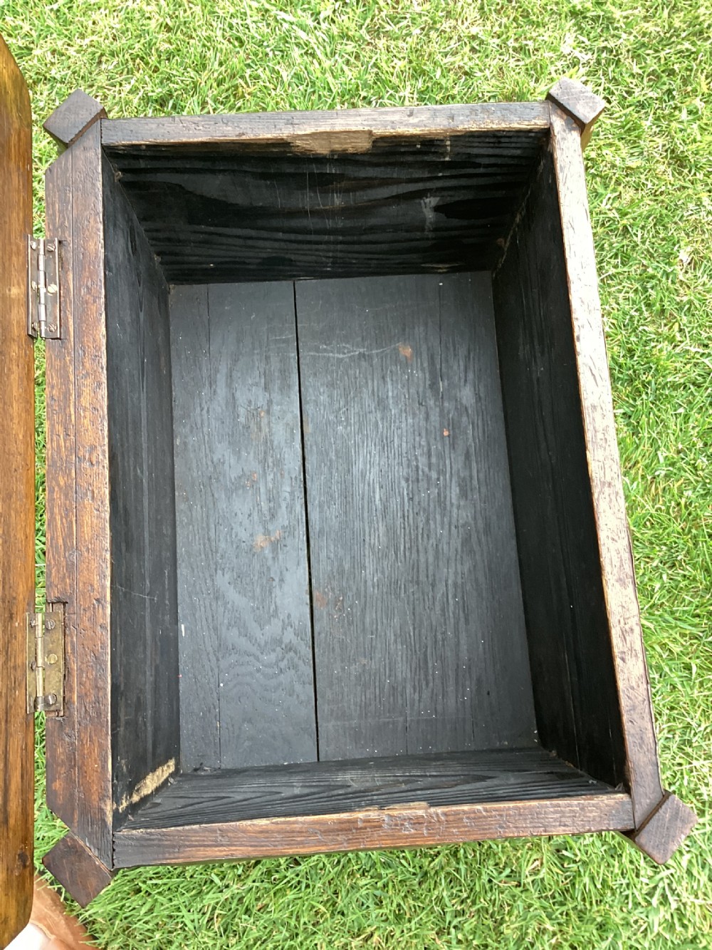An Arts and Crafts oak log box featuring hammered copper panels with decorative repousse detailing and riveted edges. View XIV