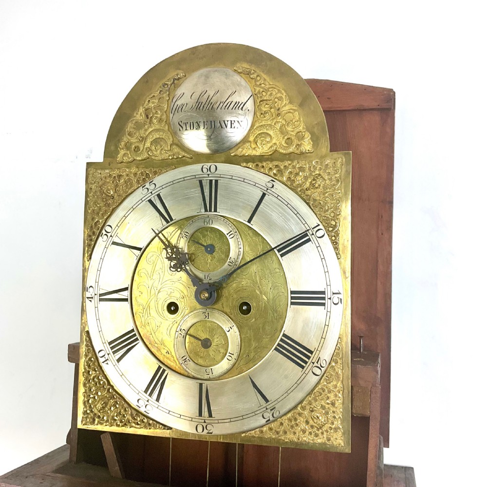 A late Georgian mahogany longcase clock featuring a swan-neck pediment, twisted columns, and an arched dial with silvered chapter ring. View XII