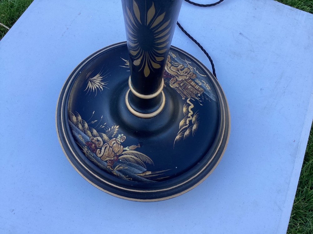 A tall black lacquered floor lamp decorated with hand-painted gold Chinoiserie motifs on a turned stem and circular base. View III