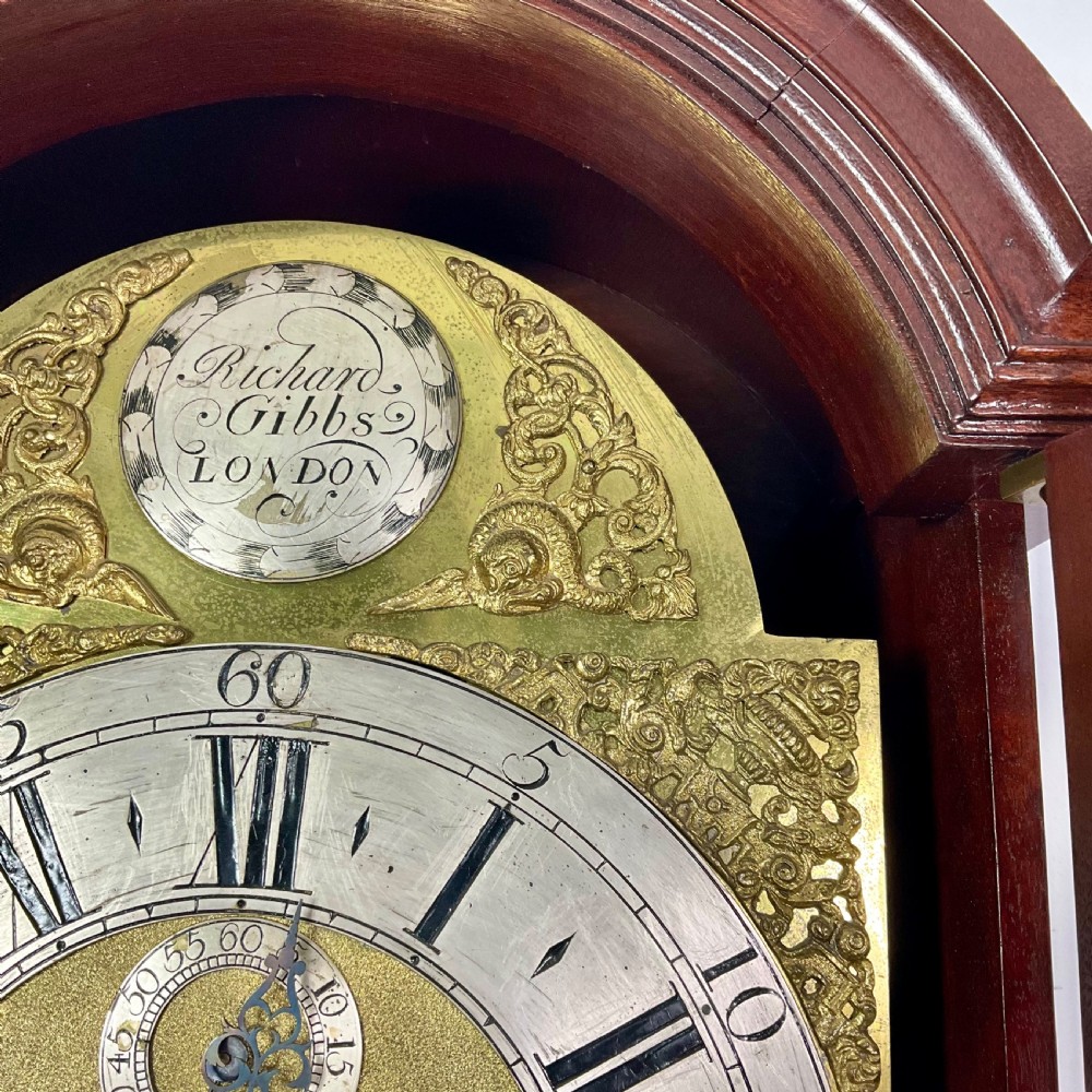 An 18th-century Georgian mahogany longcase clock featuring an arched brass dial with an engraved maker silvered boss and brass spandrels. View VII
