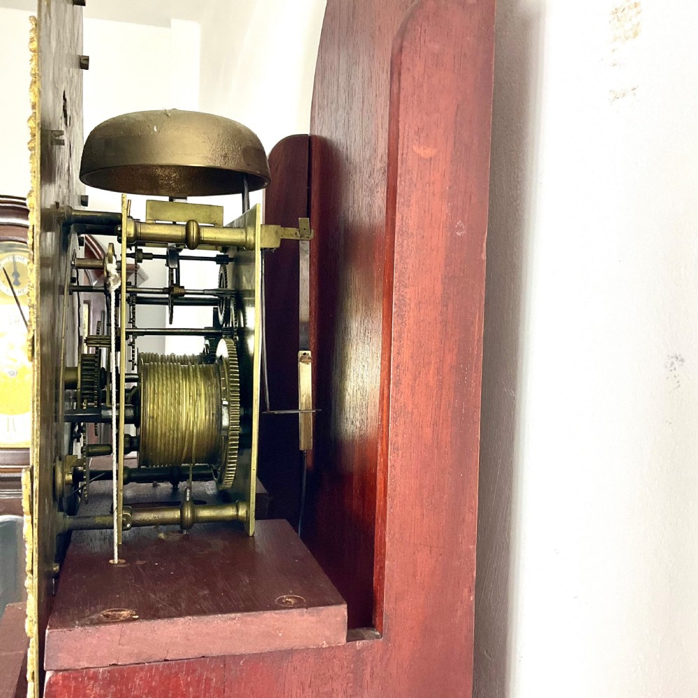 An 18th-century Georgian mahogany longcase clock featuring an arched brass dial with an engraved maker silvered boss and brass spandrels. View XIII