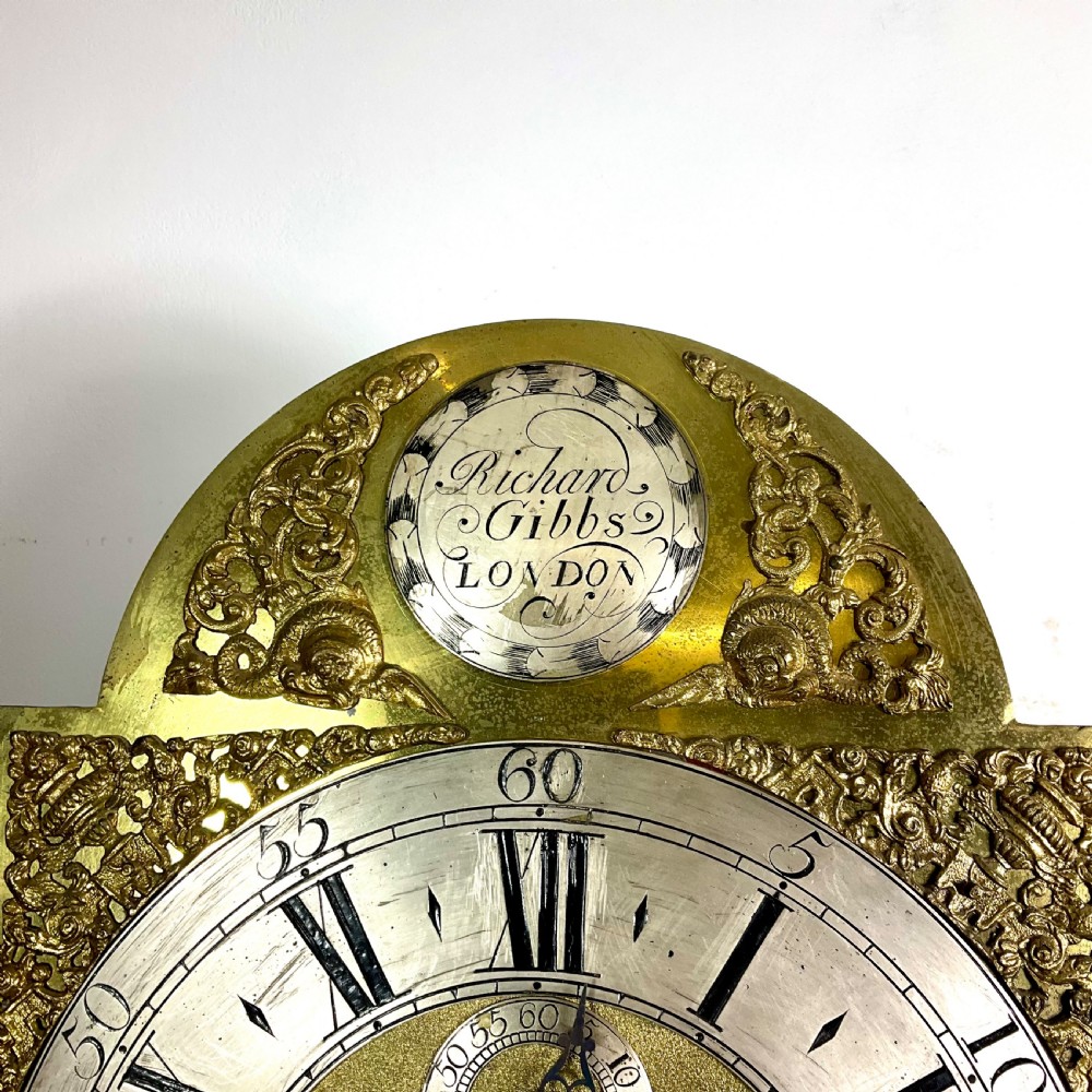 An 18th-century Georgian mahogany longcase clock featuring an arched brass dial with an engraved maker silvered boss and brass spandrels. View XV