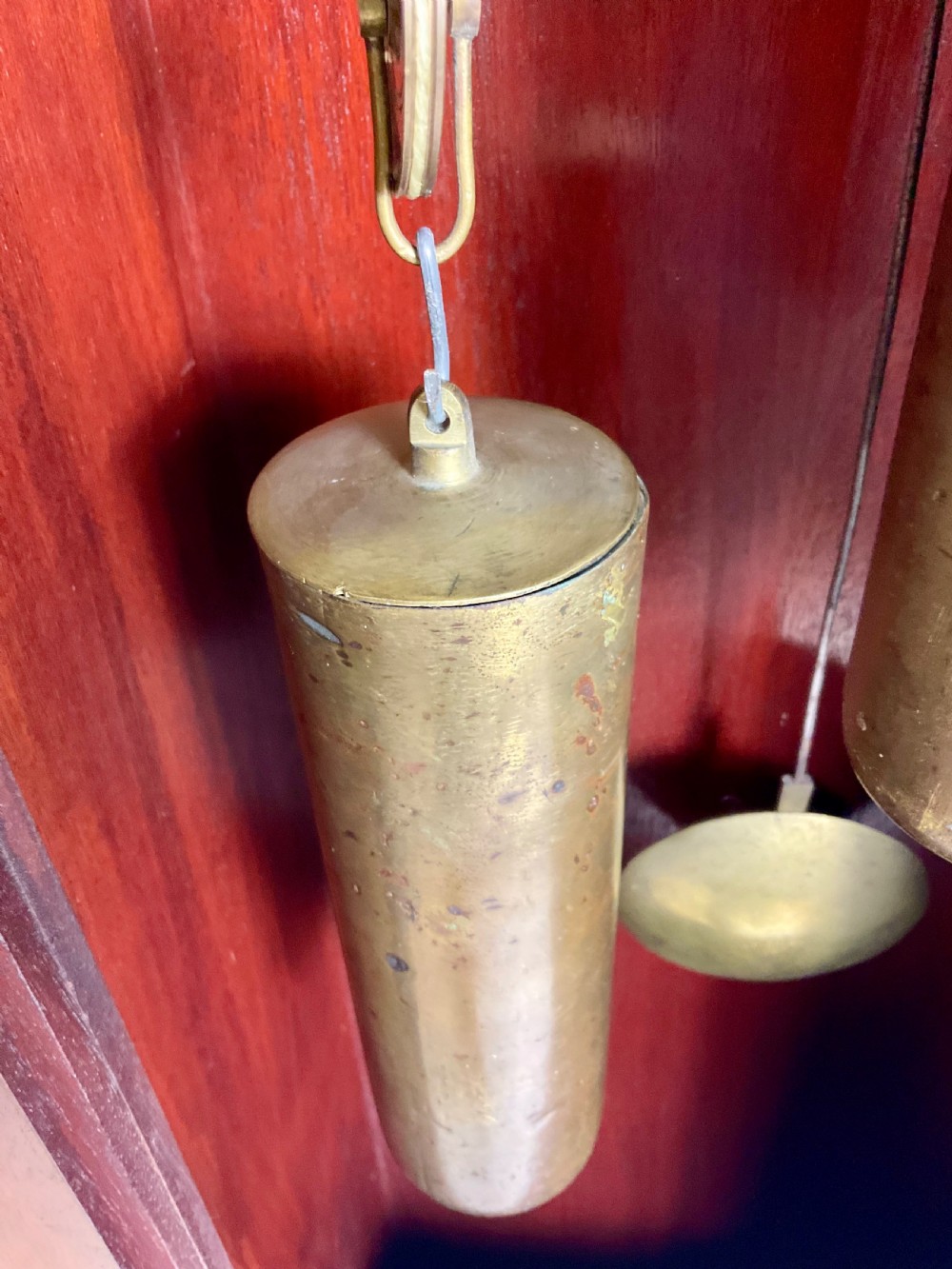 An 18th-century Georgian mahogany longcase clock featuring an arched brass dial with an engraved maker silvered boss and brass spandrels. View XVI