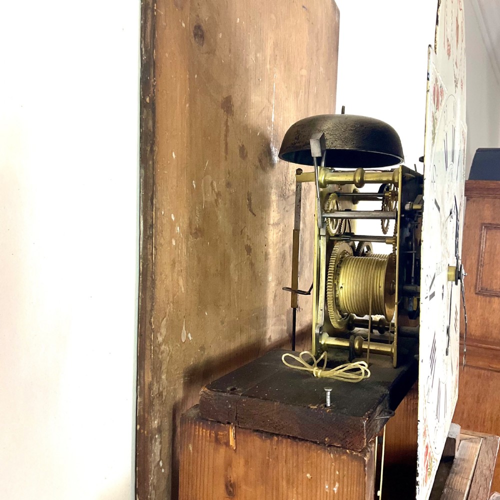 A Georgian oak longcase clock featuring a swan-neck pediment, brass ball finials, fluted columns, and a painted arch dial displaying Roman numerals. View VI