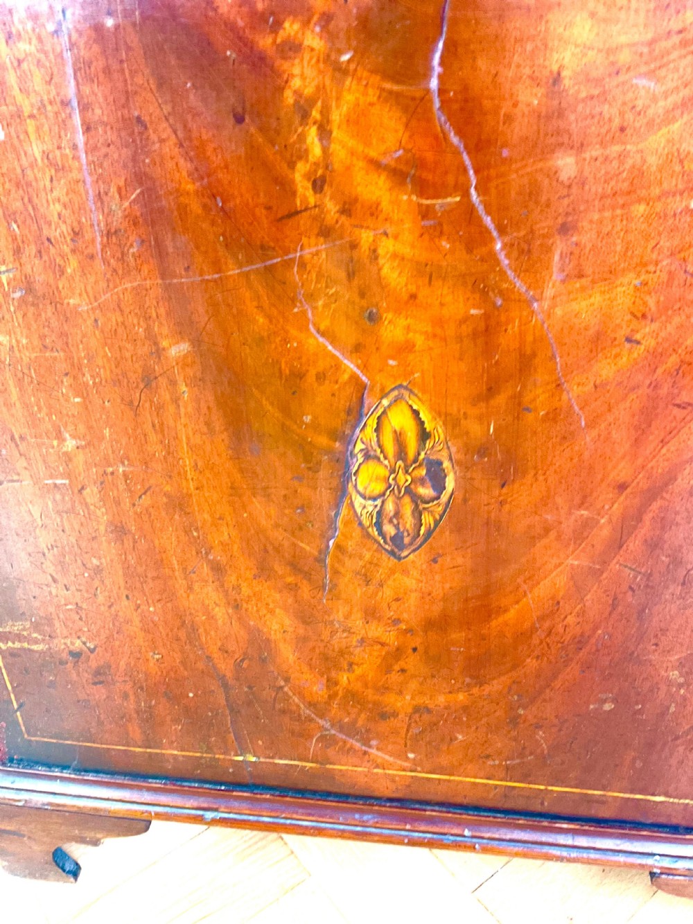 A Georgian mahogany longcase clock featuring a swan-neck pediment, painted dial, shell marquetry inlay, and reeded side columns. View IV