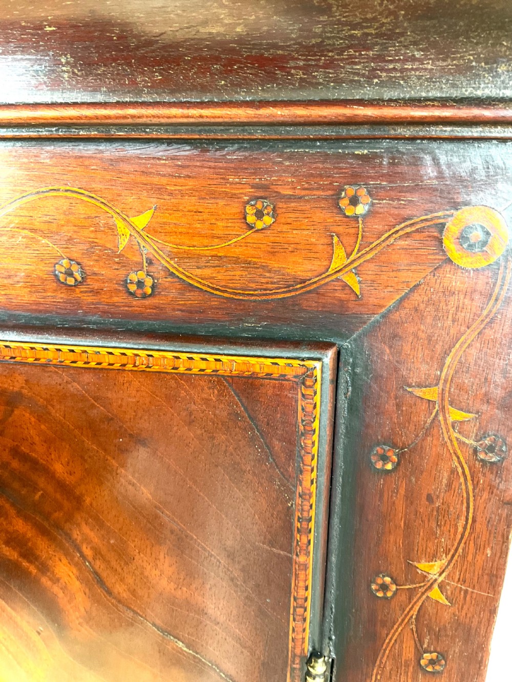 A Georgian mahogany longcase clock featuring a swan-neck pediment, painted dial, shell marquetry inlay, and reeded side columns. View V