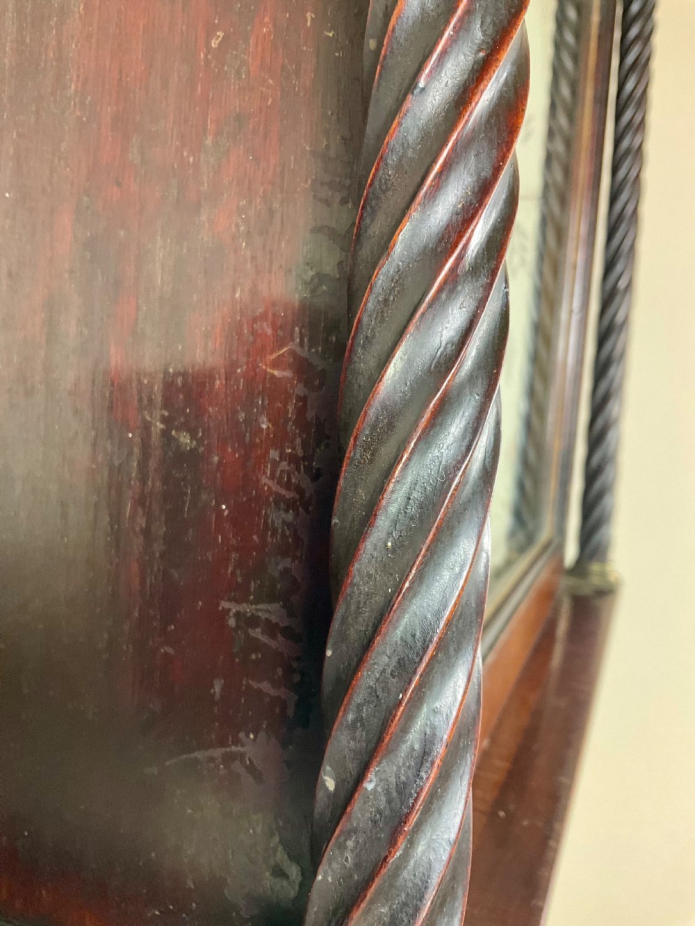 A Georgian mahogany longcase clock featuring a swan-neck pediment, painted dial, shell marquetry inlay, and reeded side columns. View VI