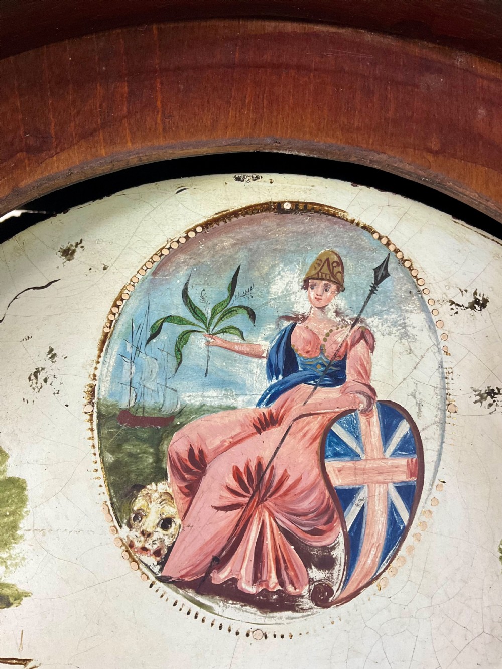 A Georgian mahogany longcase clock featuring a swan-neck pediment, painted dial, shell marquetry inlay, and reeded side columns. View VIII