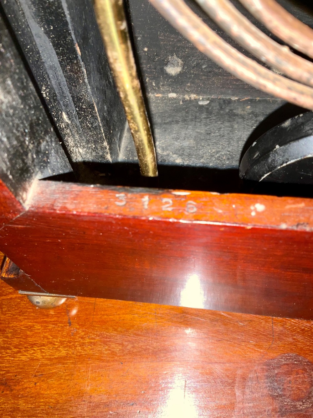 An English mahogany bracket clock featuring an arched top, white dial with Roman numerals, brass bezel, geometric marquetry inlay, and four brass ball feet. View VIII