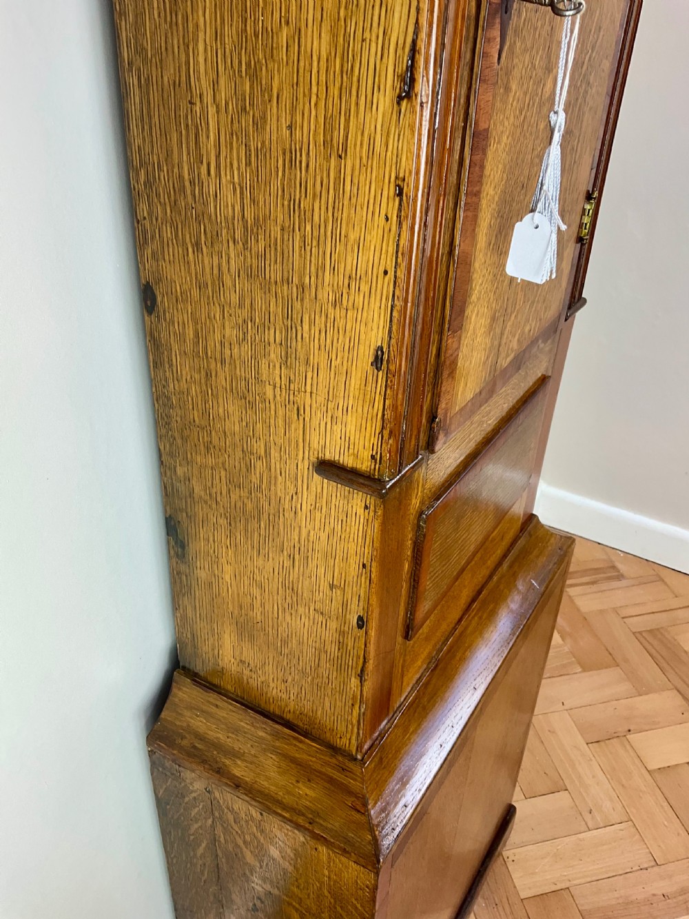 An 18th-century Georgian oak and mahogany longcase clock featuring a swan-neck pediment, fluted columns, and a painted dial face signed by Preddy of Langport. View IV