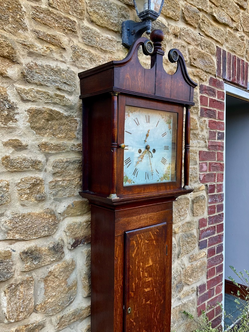 A tall Georgian longcase clock crafted from rich oak and mahogany featuring a swan-neck pediment hood and a hand-painted square dial. View II