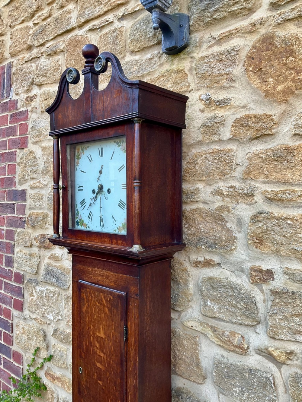 A tall Georgian longcase clock crafted from rich oak and mahogany featuring a swan-neck pediment hood and a hand-painted square dial. View VIII