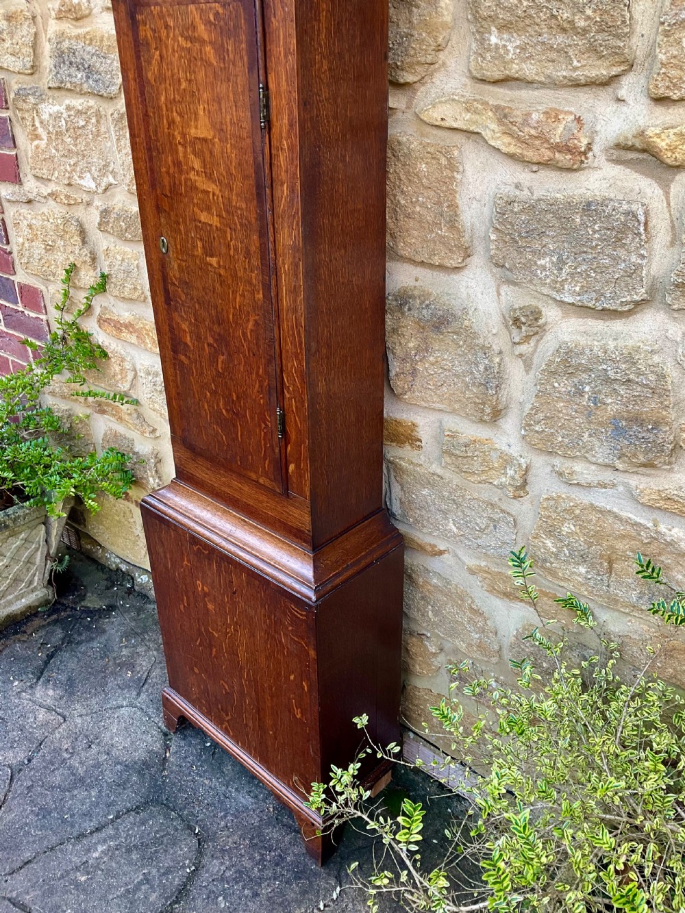 A tall Georgian longcase clock crafted from rich oak and mahogany featuring a swan-neck pediment hood and a hand-painted square dial. View IX