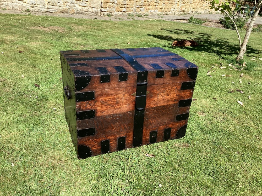 A 19th-century dark oak silver chest featuring black metal binding straps, corner plates, and central locking mechanism. View II