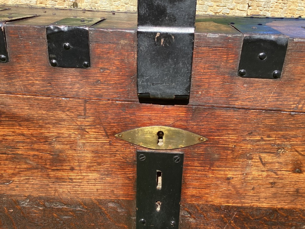 A 19th-century dark oak silver chest featuring black metal binding straps, corner plates, and central locking mechanism. View V