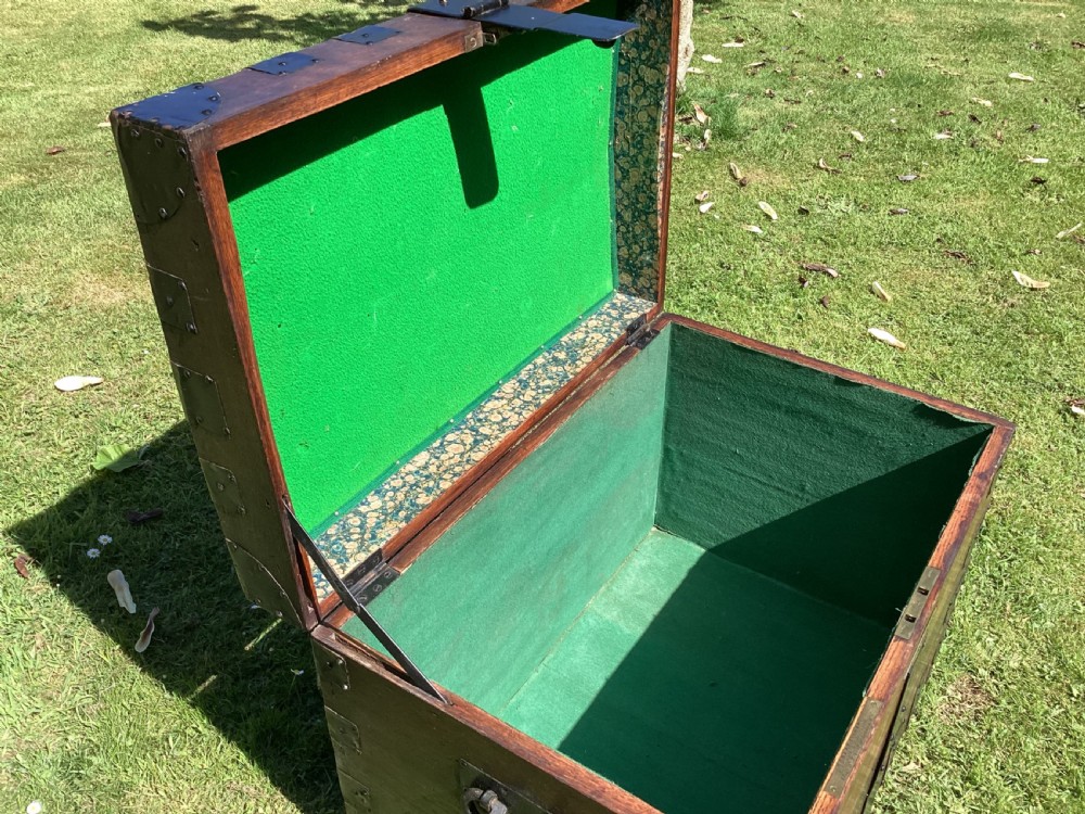 A 19th-century dark oak silver chest featuring black metal binding straps, corner plates, and central locking mechanism. View VI