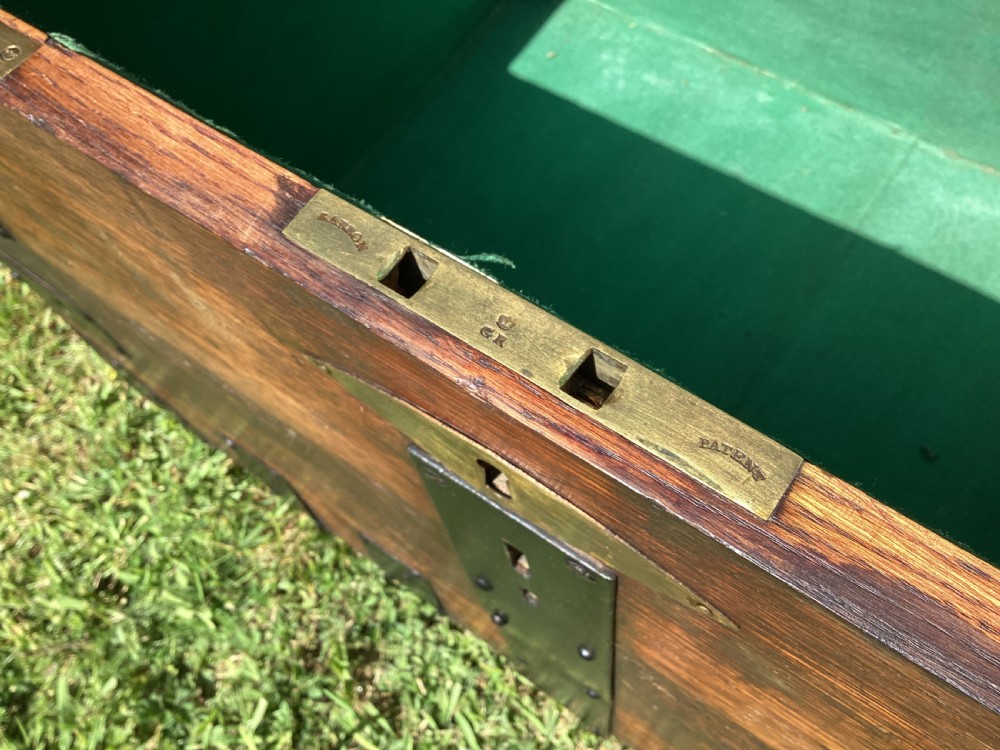 A 19th-century dark oak silver chest featuring black metal binding straps, corner plates, and central locking mechanism. View VIII
