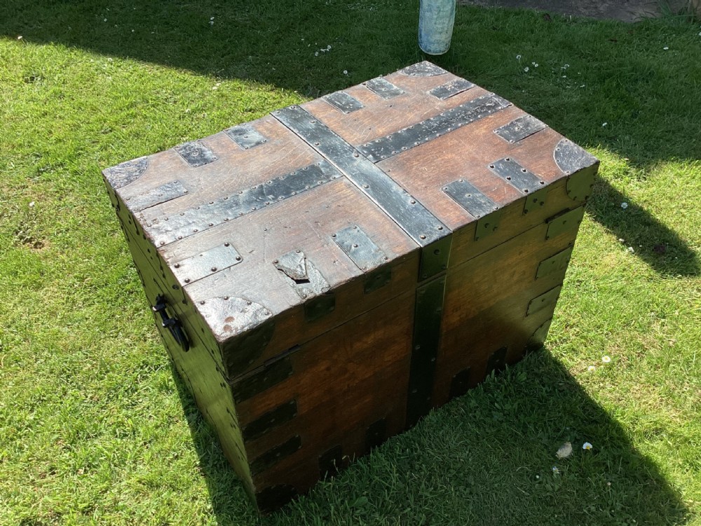 A 19th-century dark oak silver chest featuring black metal binding straps, corner plates, and central locking mechanism. View X
