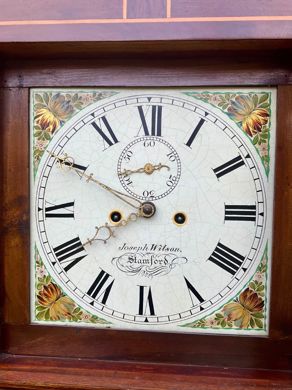 A Georgian oak and mahogany longcase clock featuring a swan-neck pediment, fluted hood columns, and a painted square dial. View III