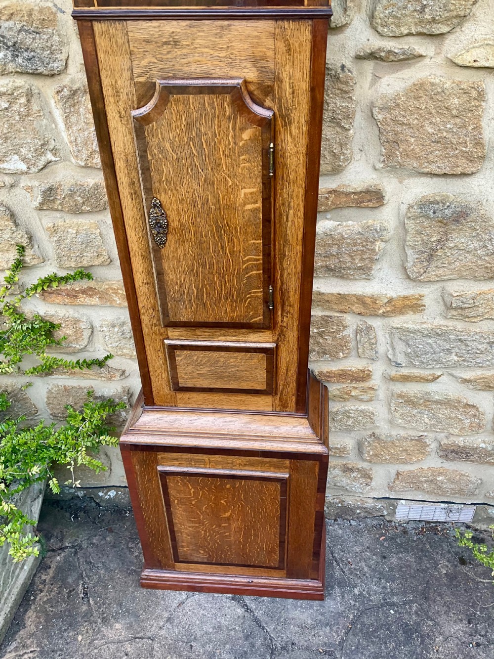A Georgian oak and mahogany longcase clock featuring a swan-neck pediment, fluted hood columns, and a painted square dial. View V