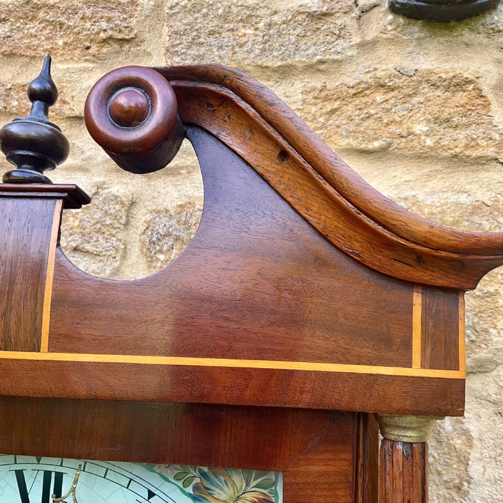 A Georgian oak and mahogany longcase clock featuring a swan-neck pediment, fluted hood columns, and a painted square dial. View VII