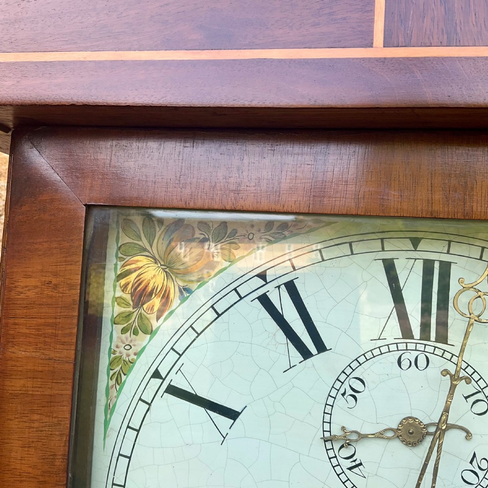 A Georgian oak and mahogany longcase clock featuring a swan-neck pediment, fluted hood columns, and a painted square dial. View XI