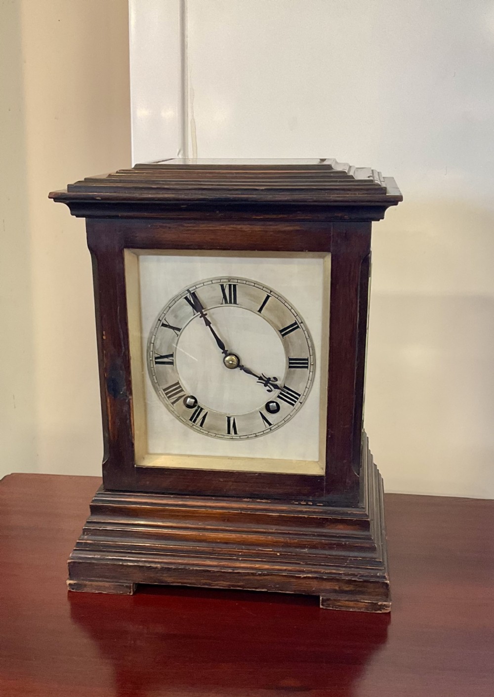 A Victorian dark mahogany five-glass bracket clock featuring a square white dial with Roman numerals and a stepped moulded base.